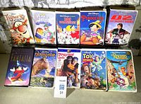 All ten VHS tapes arranged upright showing front cover art and clamshells/slipcases