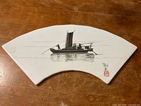 Front view showing full boat artwork on fan-shaped plaque