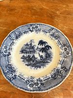 Full front view of porcelain dinner plate showing entire scenic pattern