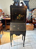 Full view of black painted chinoiserie secretary desk showing drop-front and drawer