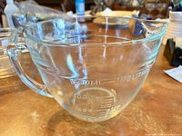 Side view showing full profile, handle, spout and embossed 1000 ml marking