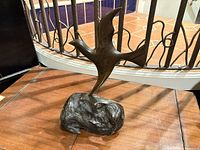 Front view of wooden bird sculpture on bog oak base