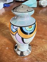 Front view showing multicolor design and chrome base