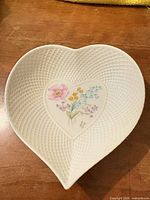 Full view of heart-shaped dish showing lattice texture and floral center