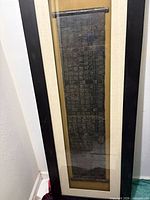 Full view of framed metal wall art in portrait orientation