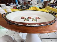 Top view of ceramic platter in metal stand showing leaf pattern and rims