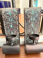 Front view of both sconces showing metal frames, mosaic ceramic inlay and candle cups