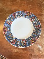 Top view of the porcelain dinner plate showing floral border and gold rim