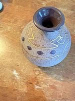Side view showing overall vase shape, color, and decorative motifs