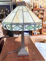 Full view of stained glass table lamp showing shade, base and cord