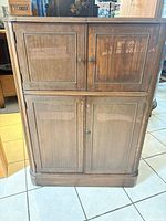 Front view of closed cabinet showing four panel doors and overall condition