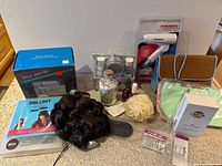 Group shot showing all items including hair tools, skincare, gift set, accessories