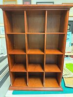 Front view of 12-cubby wooden display shelf