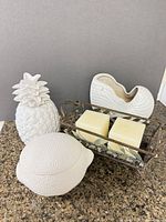 Group shot showing all items: Partylite candle holder with candles, ceramic pineapple, lemon container, nautilus shell