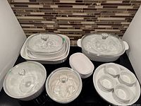 Group shot of all CorningWare French White pieces showing size range and lids