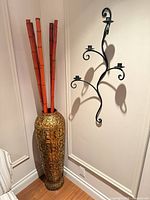 Corner view showing both vase with bamboo and wall candle holder