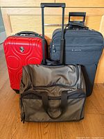 Three pieces of luggage standing upright