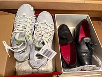 Avia runners and Grenson loafers side by side in boxes