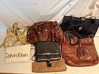 Group shot showing all five handbags with protective covers