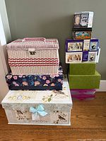 Group shot of sewing basket, decorative boxes and containers stacked