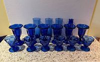 Group shot of all cobalt blue glasses and vase