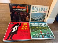 Eight record jackets laid out: Inti-Illimani, Your Musical Holiday in the Alps, The 3rd Man Theme, Call of the Valley