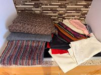 Stack of assorted fabric pieces on counter