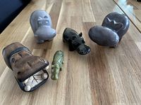 front angled view of all five hippo figurines