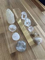 All nine crystal specimens with brass ruler for scale