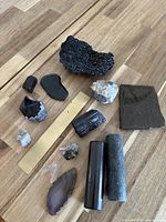 All 12 mineral pieces grouped with ruler and stand