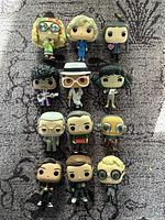 Front view of 12 loose Funko Pop figures arranged in rows