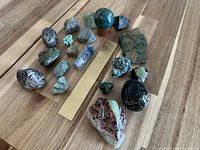 All 19 mineral specimens arranged with brass ruler for scale