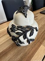 jar with lid in place showing full relief design