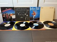 Front jackets of all four albums with two records displayed