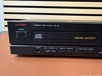 Front left showing Luxman logo, tray, digital output label, power button and headphone jack