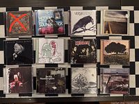 Front covers of all eleven included CD cases (one case in photo marked with red X not included)