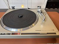 Overall view of Pioneer PL-200 turntable with dust cover open, platter and tonearm visible