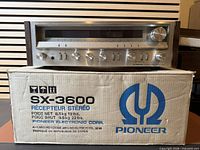 Receiver on top of original Pioneer box, front view