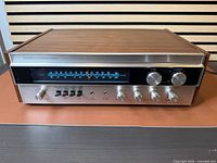 Front three-quarter view showing wood case, faceplate, controls, tuning dial