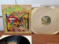 Steely Dan LP with jacket; Fleetwood Mac LP in paper sleeve; partial view of Steely Dan record