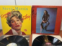Front jackets of both LPs with records partially visible