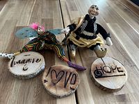 Both figures and three wood slices displayed together on table