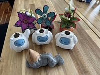 Full group shot of gnome, three yeti planters, three felt plants