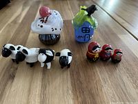 Group shot of all nine glass figurines on wooden surface