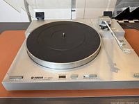 Top view of Yamaha P-450 turntable with lid open, showing platter, tonearm and controls