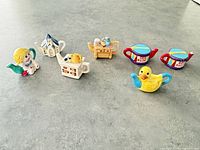 All seven miniature teapot figurines displayed
