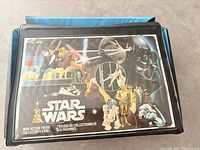 Closed black vinyl Star Wars collector case with graphics