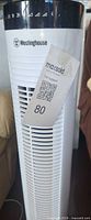 Full front view of Westinghouse tower fan with lot tag