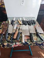 Overall lot of knives laid out on table