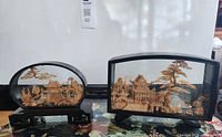 Both cork dioramas side by side showing relative size and frames